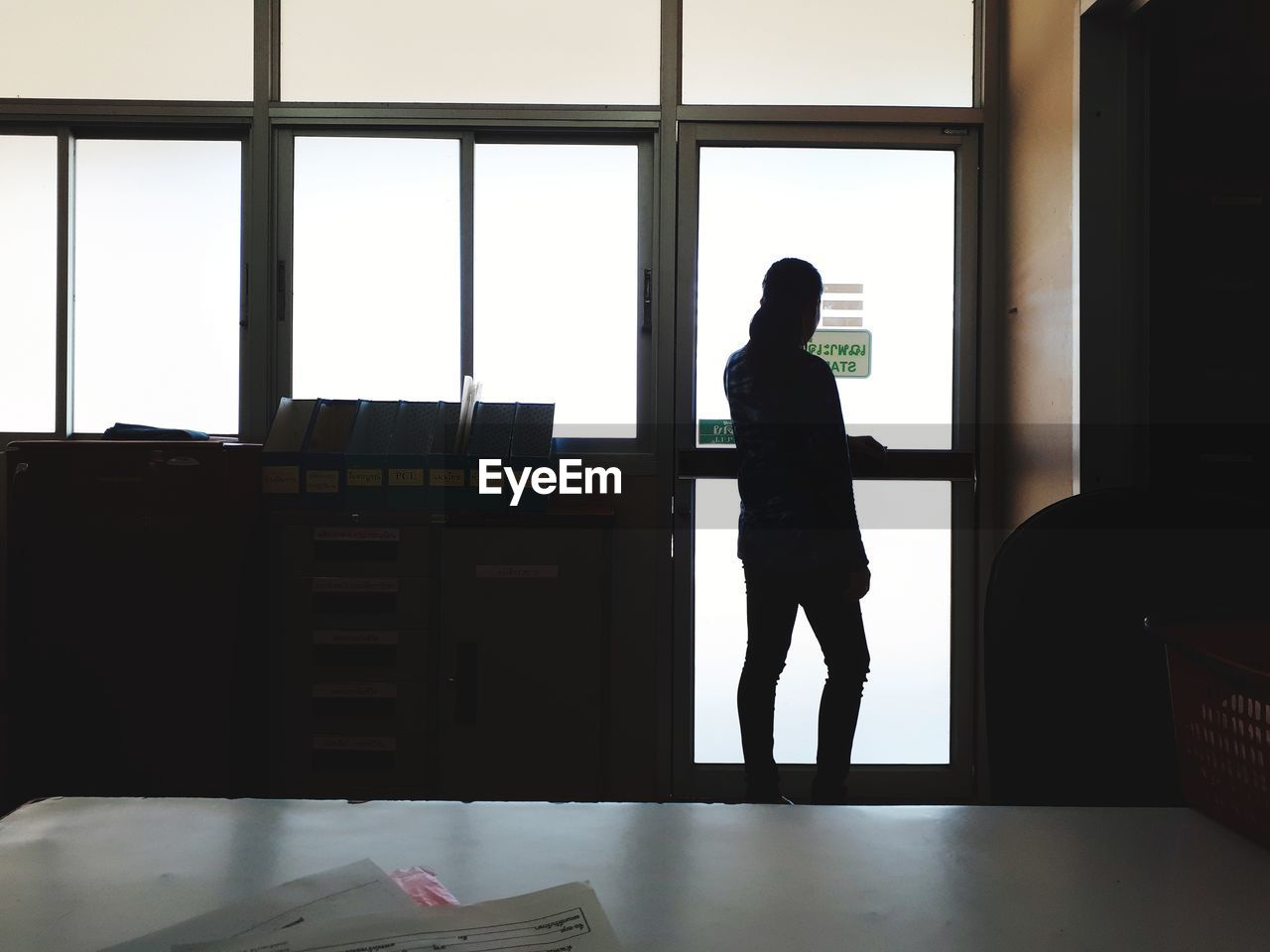 SILHOUETTE WOMAN STANDING ON WINDOW