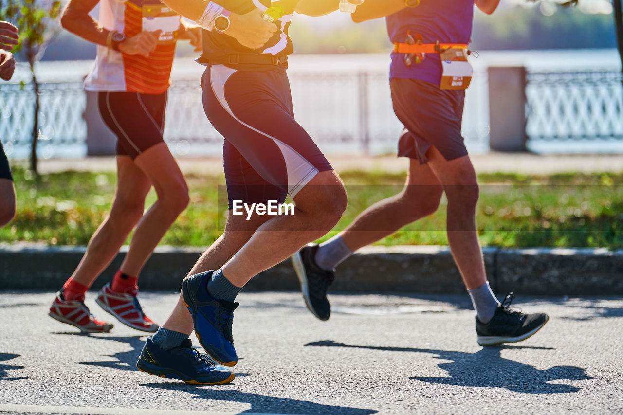 Running men. sportsmen jogging in sportswear on city road. healthy lifestyle, fitness, marathon