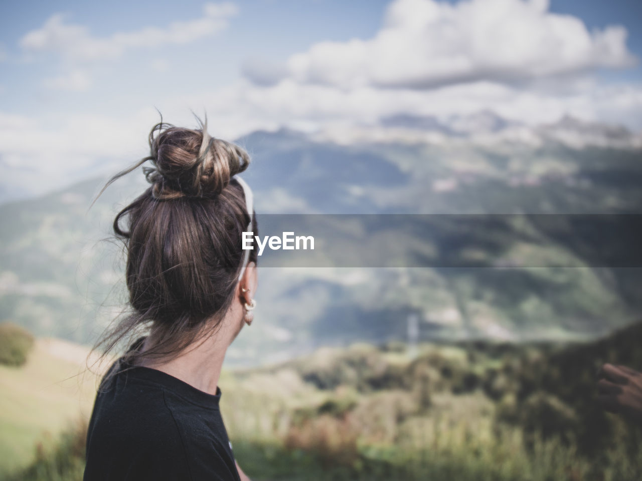 Woman looking at landscape against sky