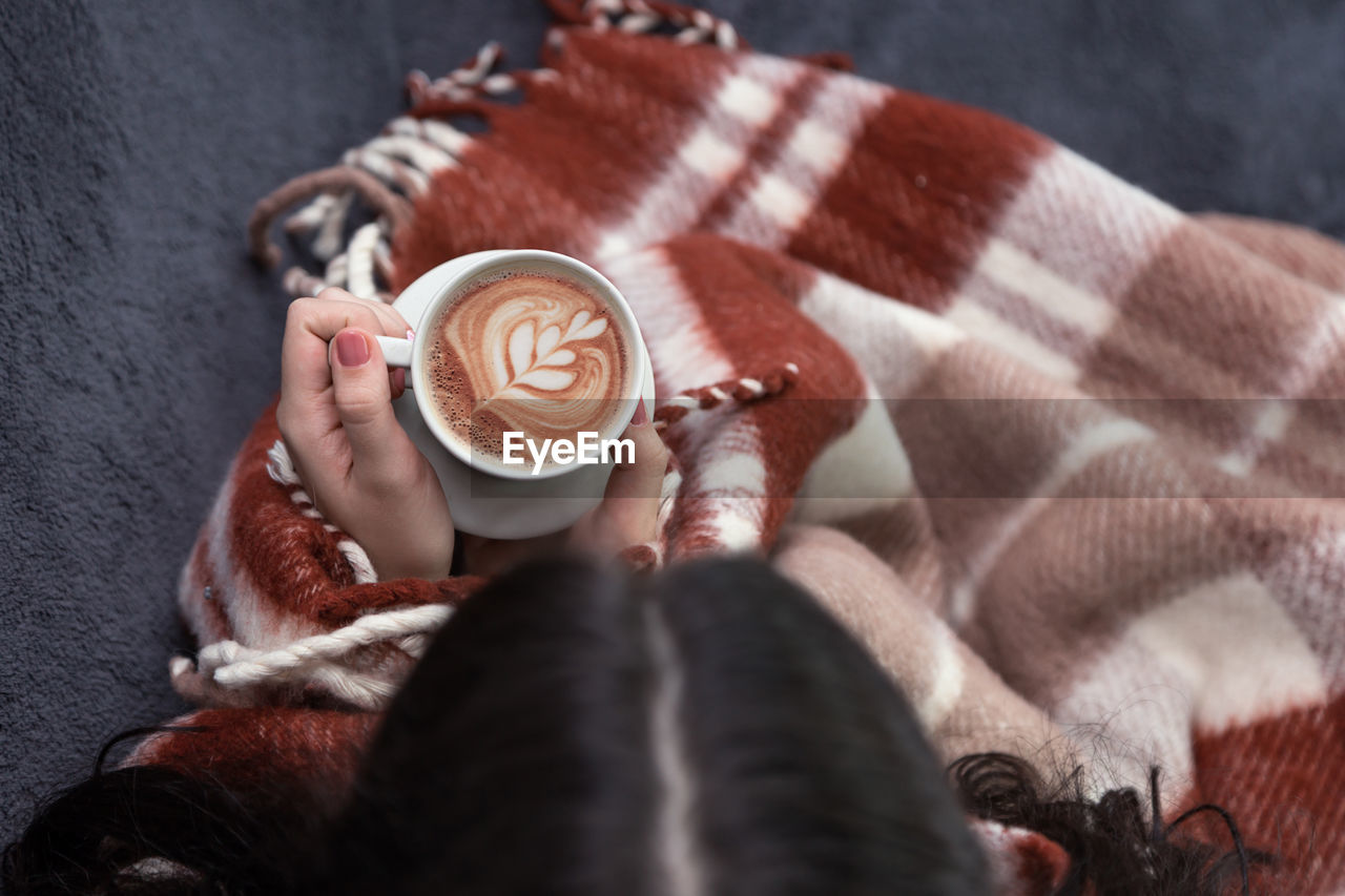 High angle view of woman having coffee