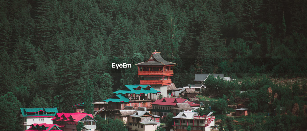 View of temple in the village in lush green mountains