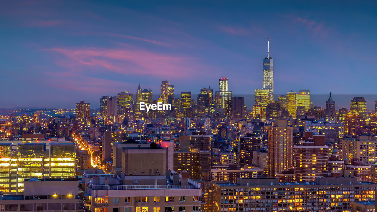 illuminated cityscape against sky at night