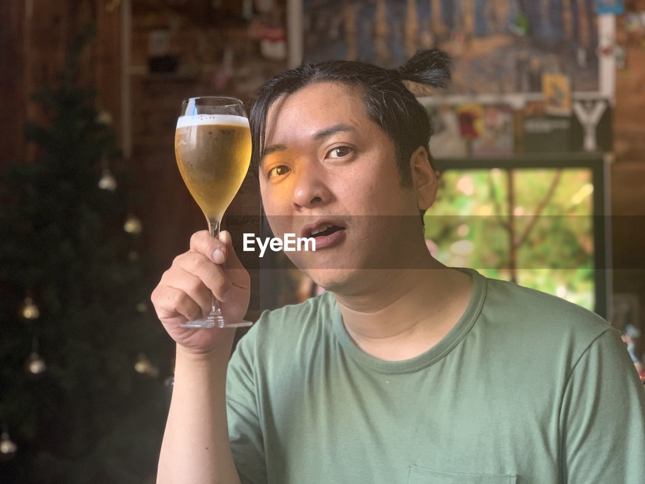 PORTRAIT OF YOUNG MAN DRINKING GLASSES