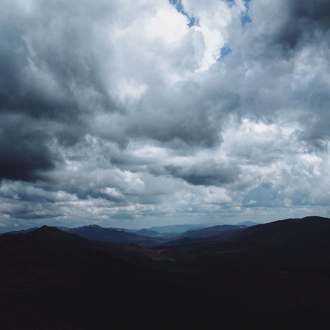 sky, cloud, environment, mountain, landscape, scenics - nature, beauty in nature, horizon, nature, dramatic sky, mountain range, storm, no people, cloudscape, land, overcast, awe, dark, storm cloud, outdoors, travel, tranquility, travel destinations, non-urban scene, dramatic landscape, plain, tranquil scene