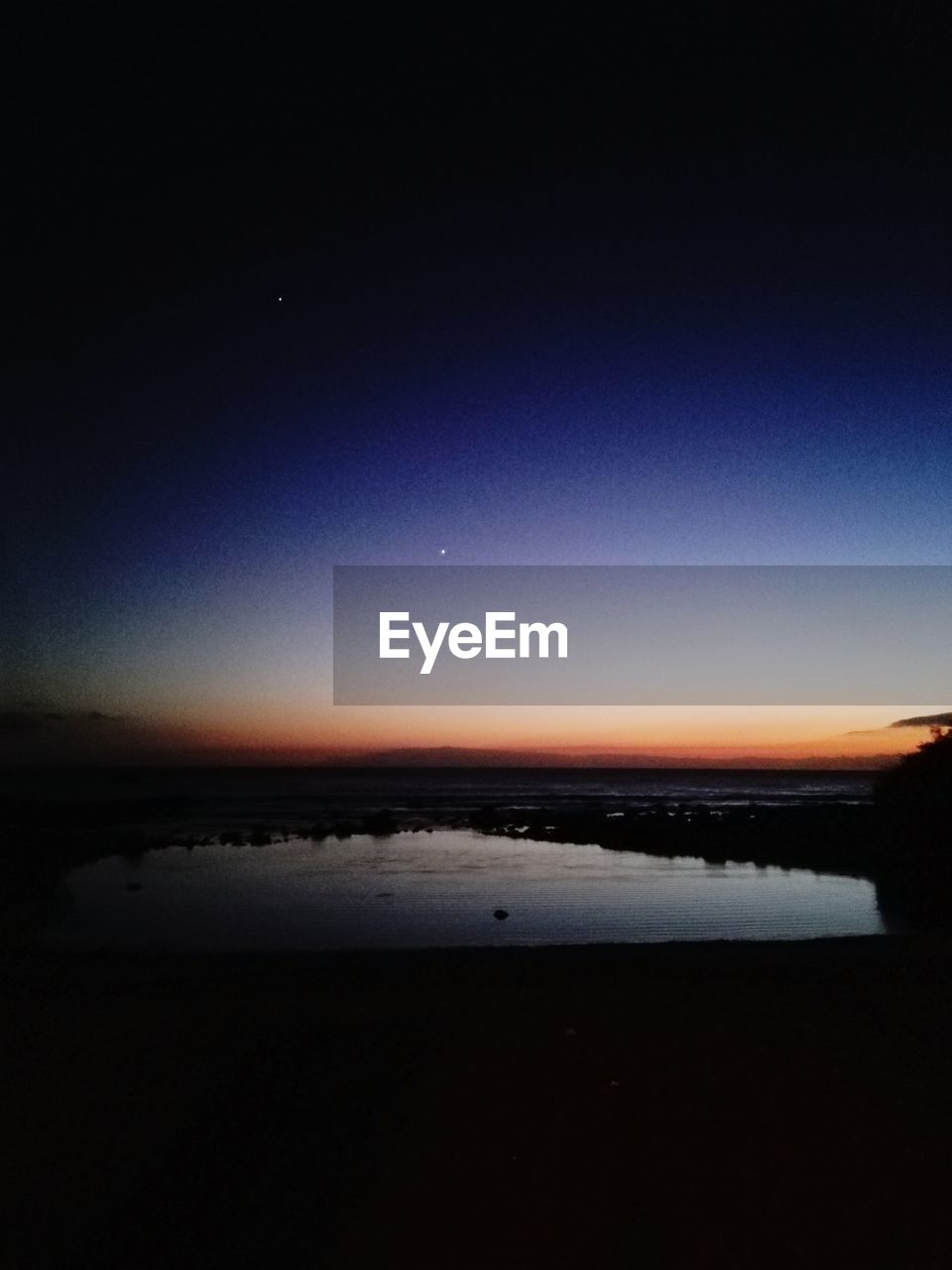 SCENIC VIEW OF BEACH AGAINST SKY AT NIGHT