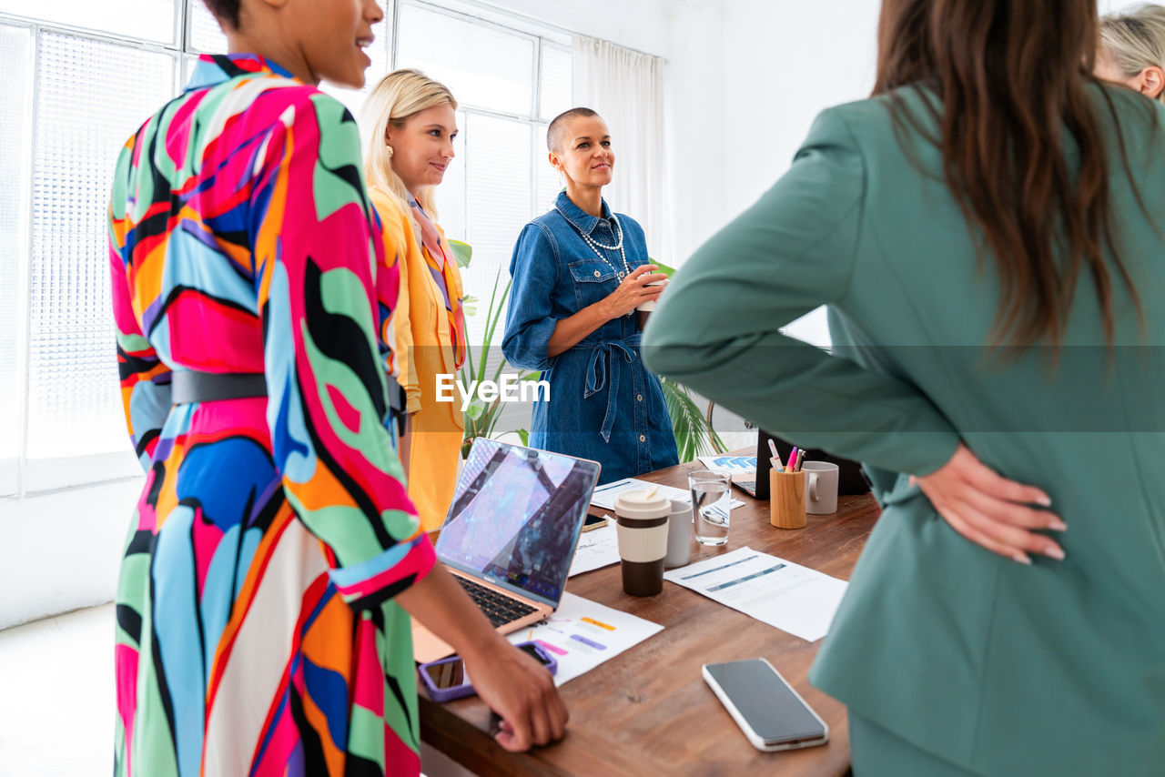 side view of business colleagues stacking hands