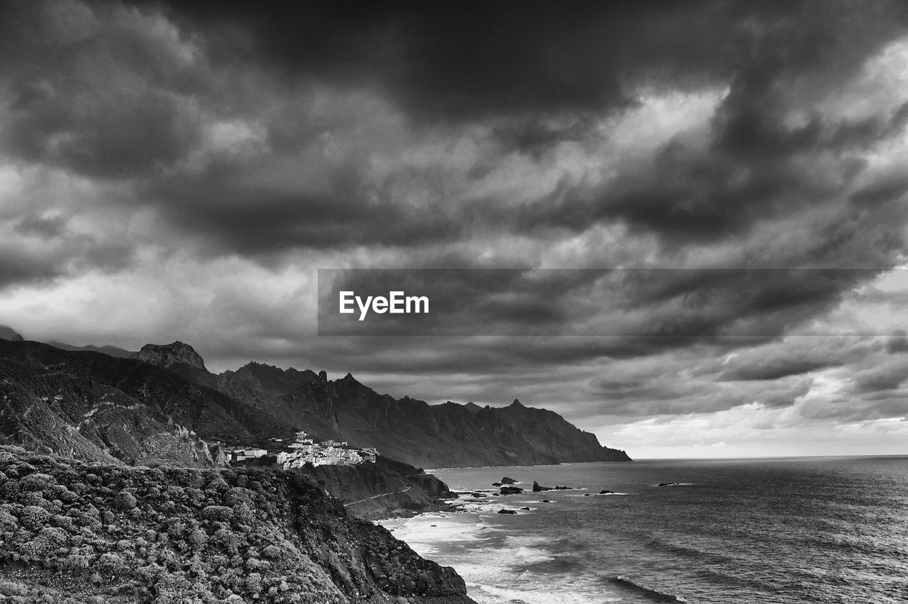 Scenic view of calm sea against cloudy sky