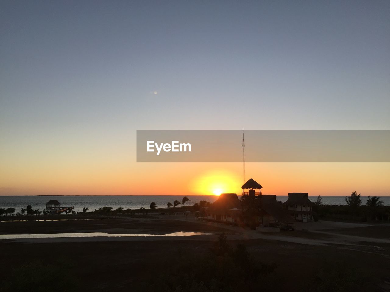 SCENIC VIEW OF SUNSET OVER BEACH