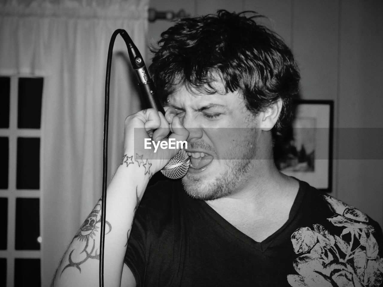 Man singing with microphone at home