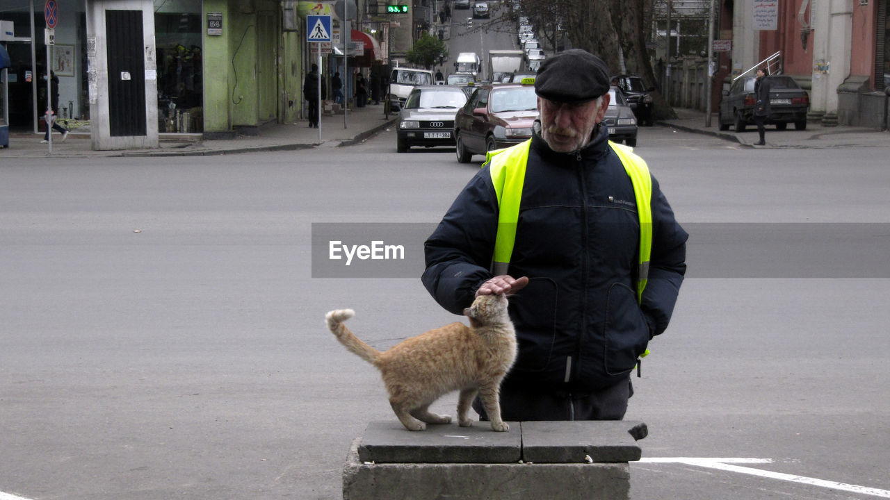 FULL LENGTH OF MAN WITH DOG ON ROAD