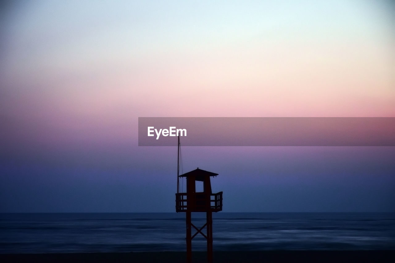 SCENIC VIEW OF SEA AGAINST ORANGE SKY