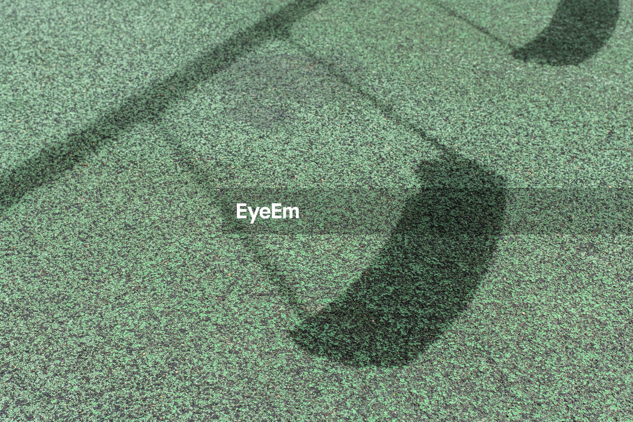 CLOSE-UP OF SHADOW ON GRASS