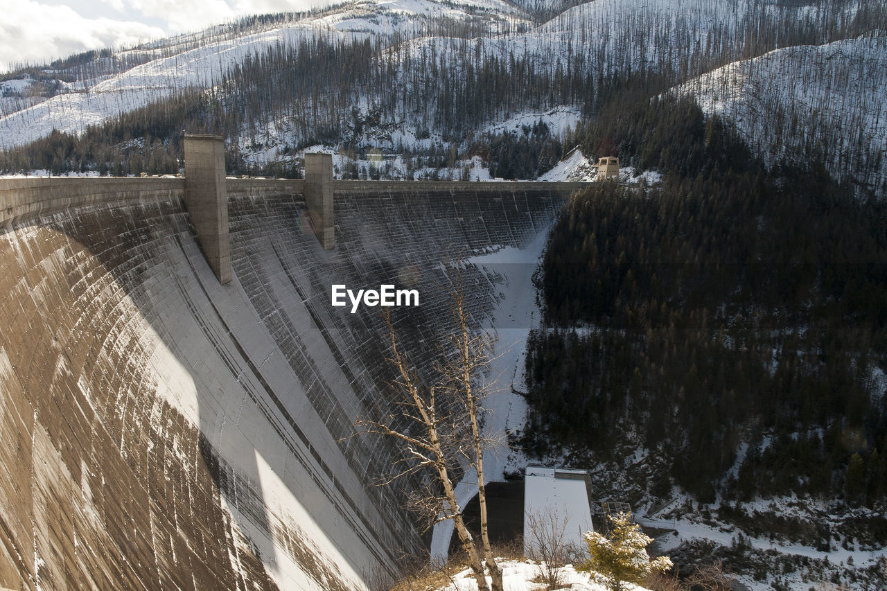 Bridge against snowcapped mountains during winter