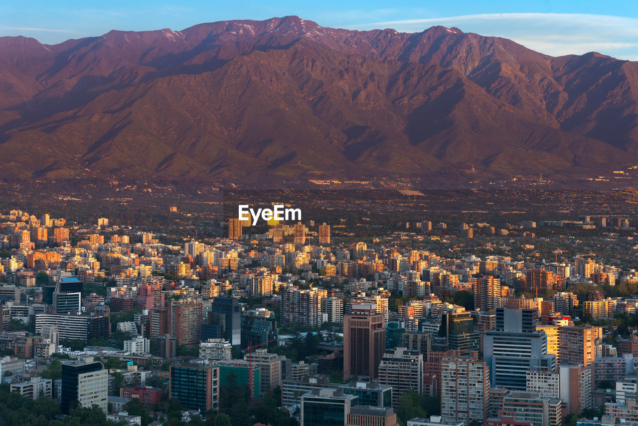 Panoramic view of providencia district with los andes mountain range in santiago de chile.