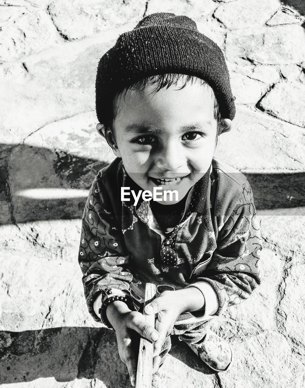 Portrait of cute boy smiling while standing outdoors