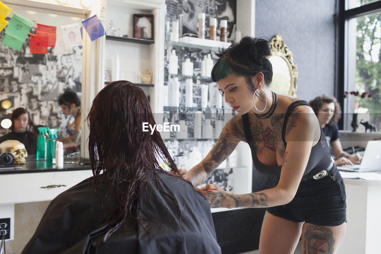 A hairdresser styling a customer's hair. 