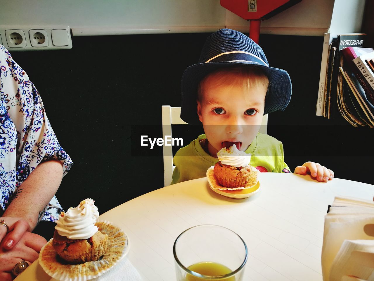 CLOSE-UP OF A BOY WITH ICE CREAM IN PLATE