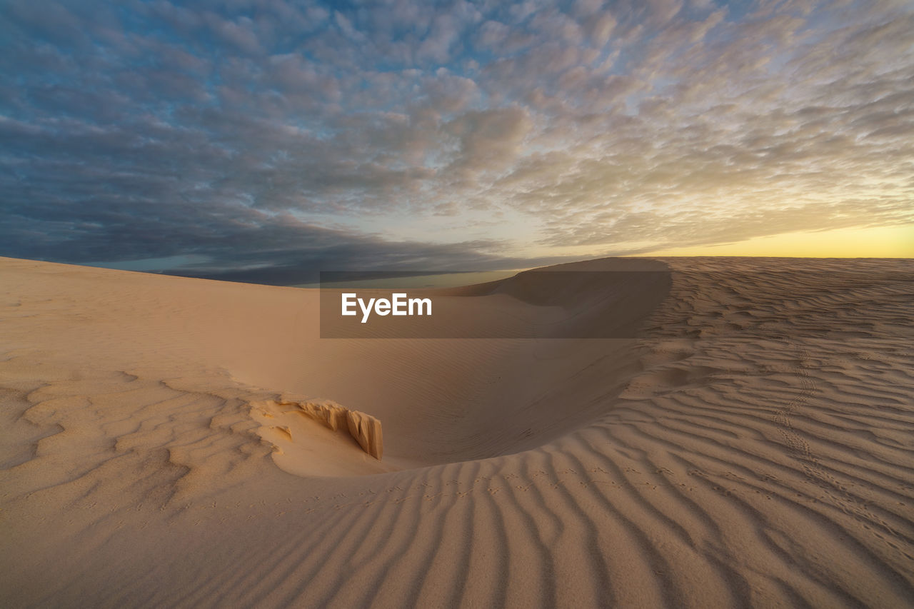 Scenic view of beach against sky during sunset