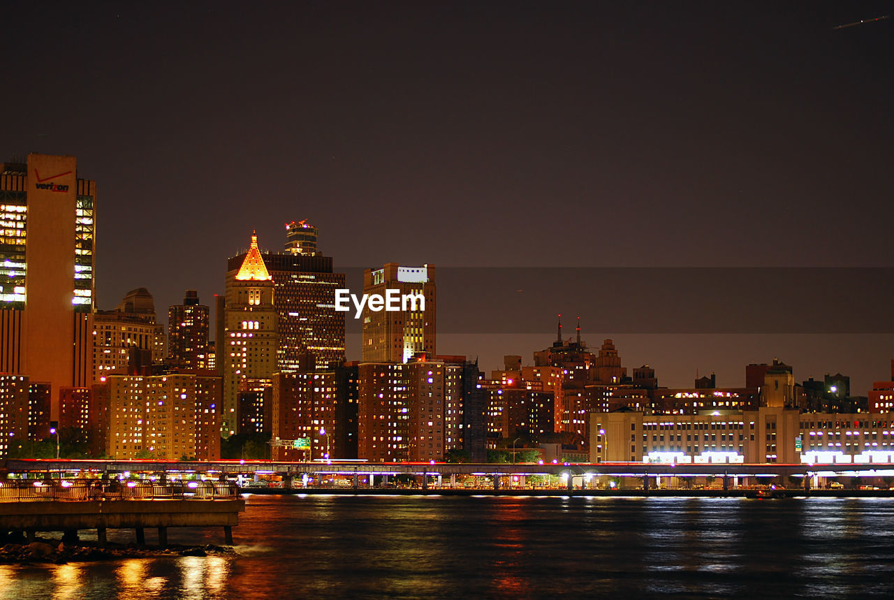 ILLUMINATED BUILDINGS IN CITY AT NIGHT