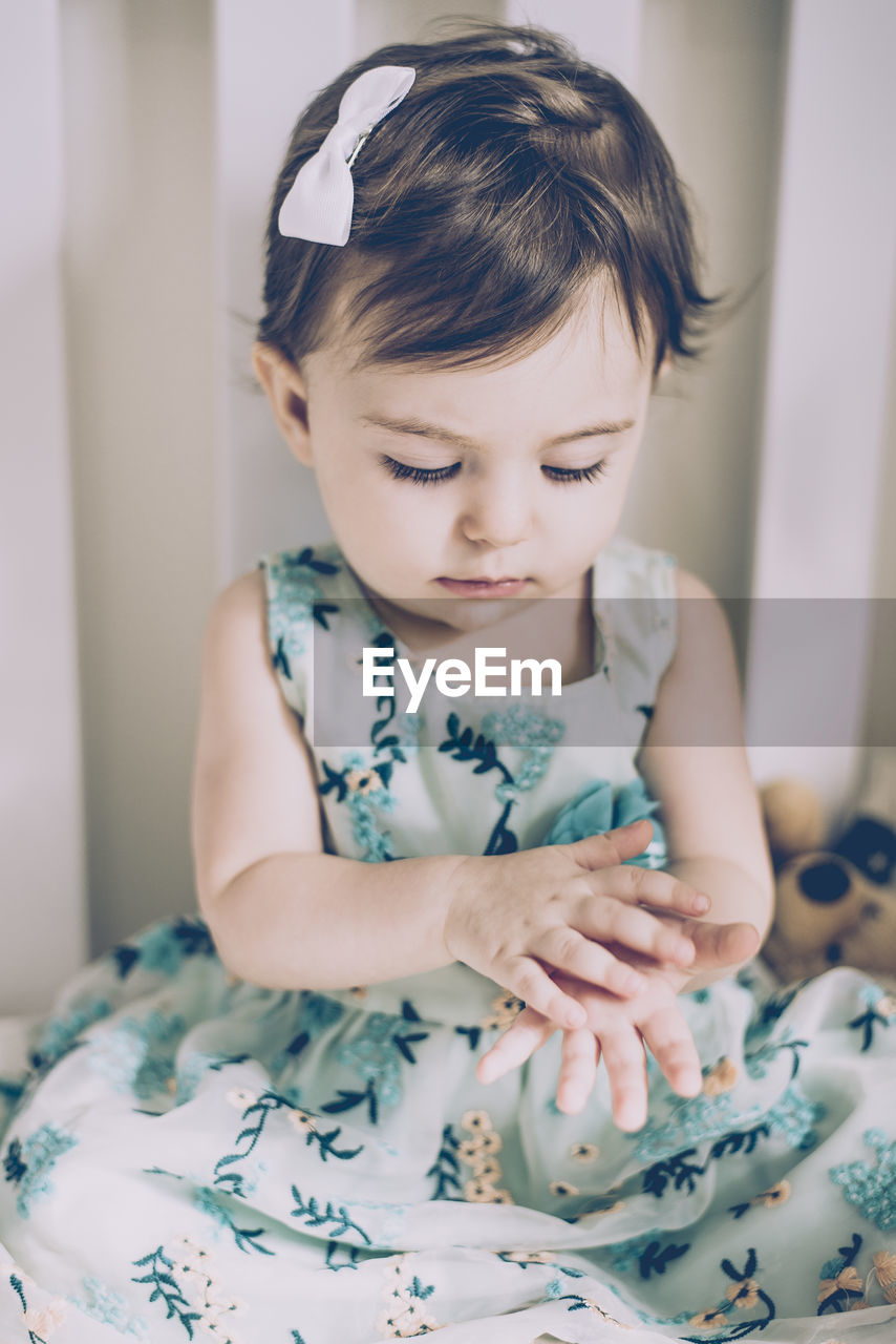 Cute baby girl sitting at home