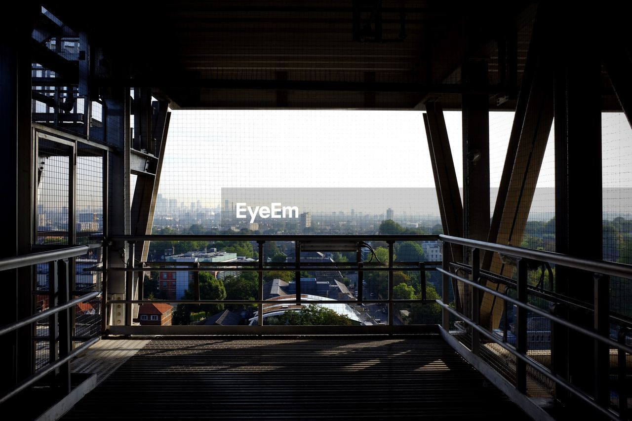 Cityscape against sky seen through bridge