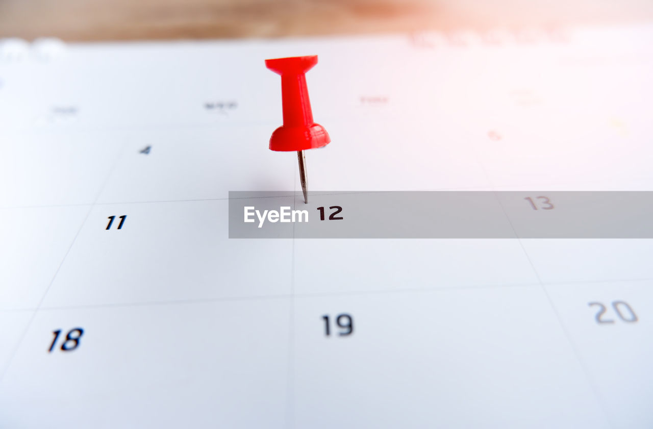 Thumbtack a date on calendar concept
