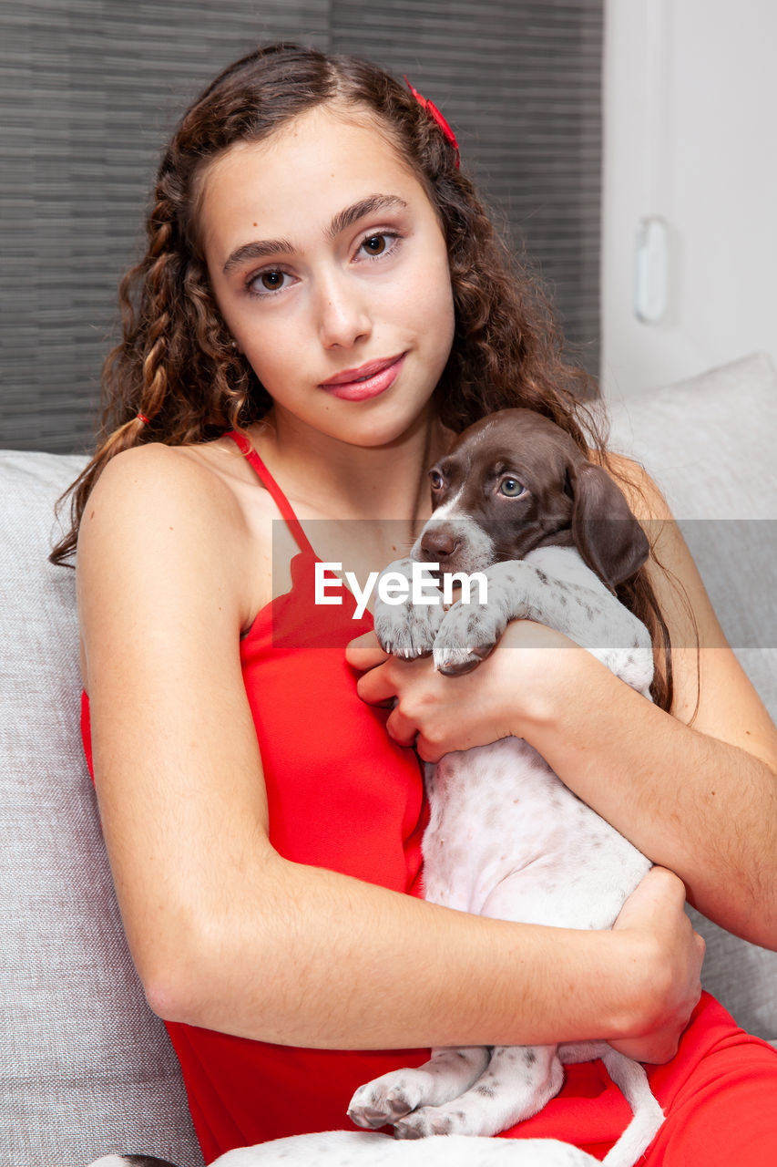 Beautiful young girl with her small french braque puppy