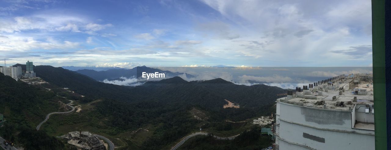 HIGH ANGLE VIEW OF BUILDINGS ON MOUNTAIN AGAINST SKY