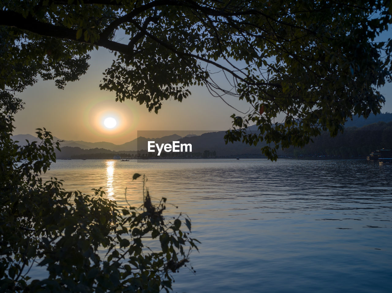 Scenic view of lake against sky during sunset