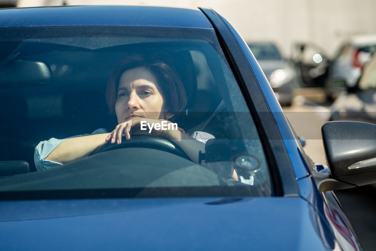 portrait of smiling young woman in car