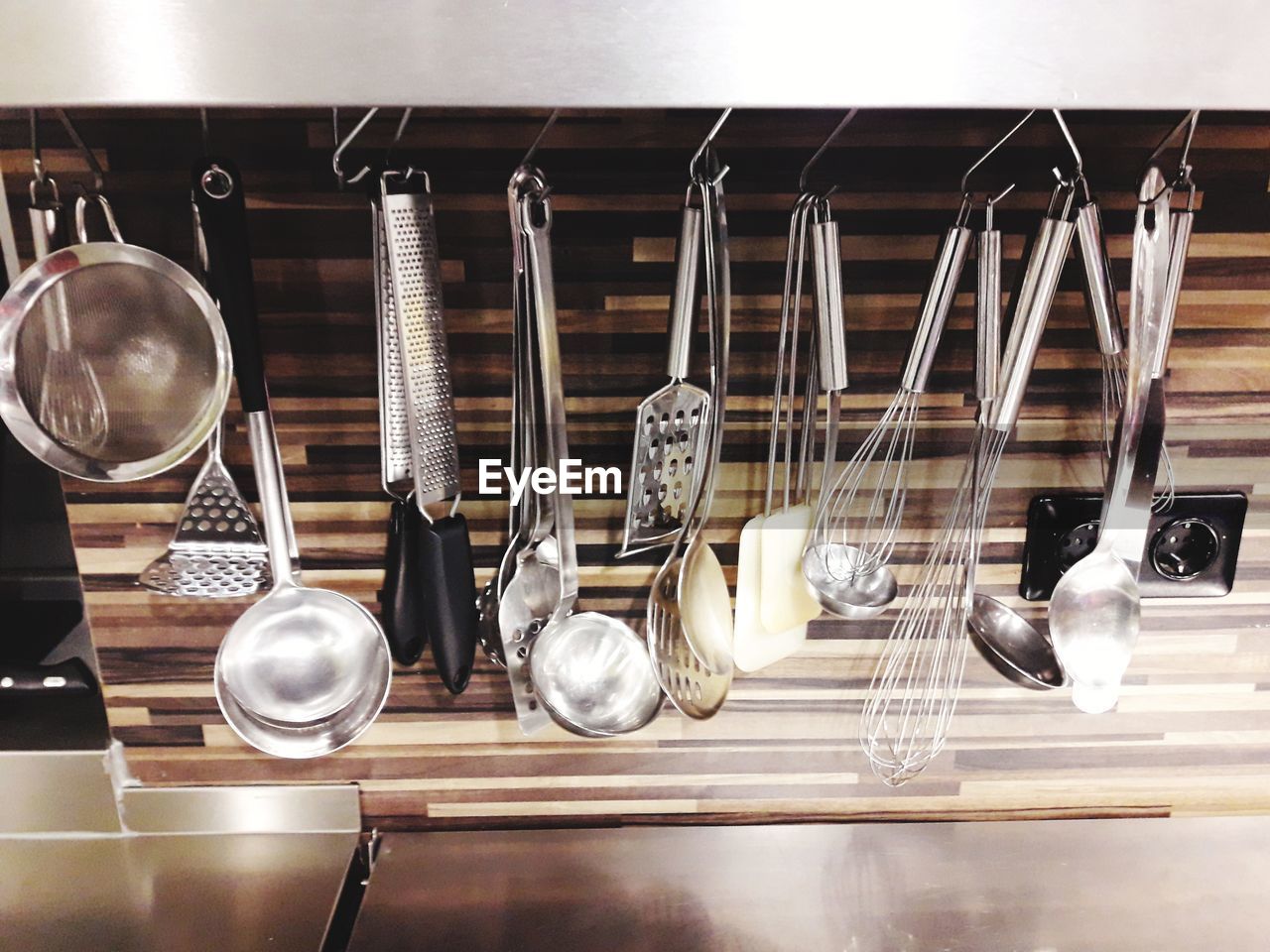 Close-up of kitchen utensils hanging on rack