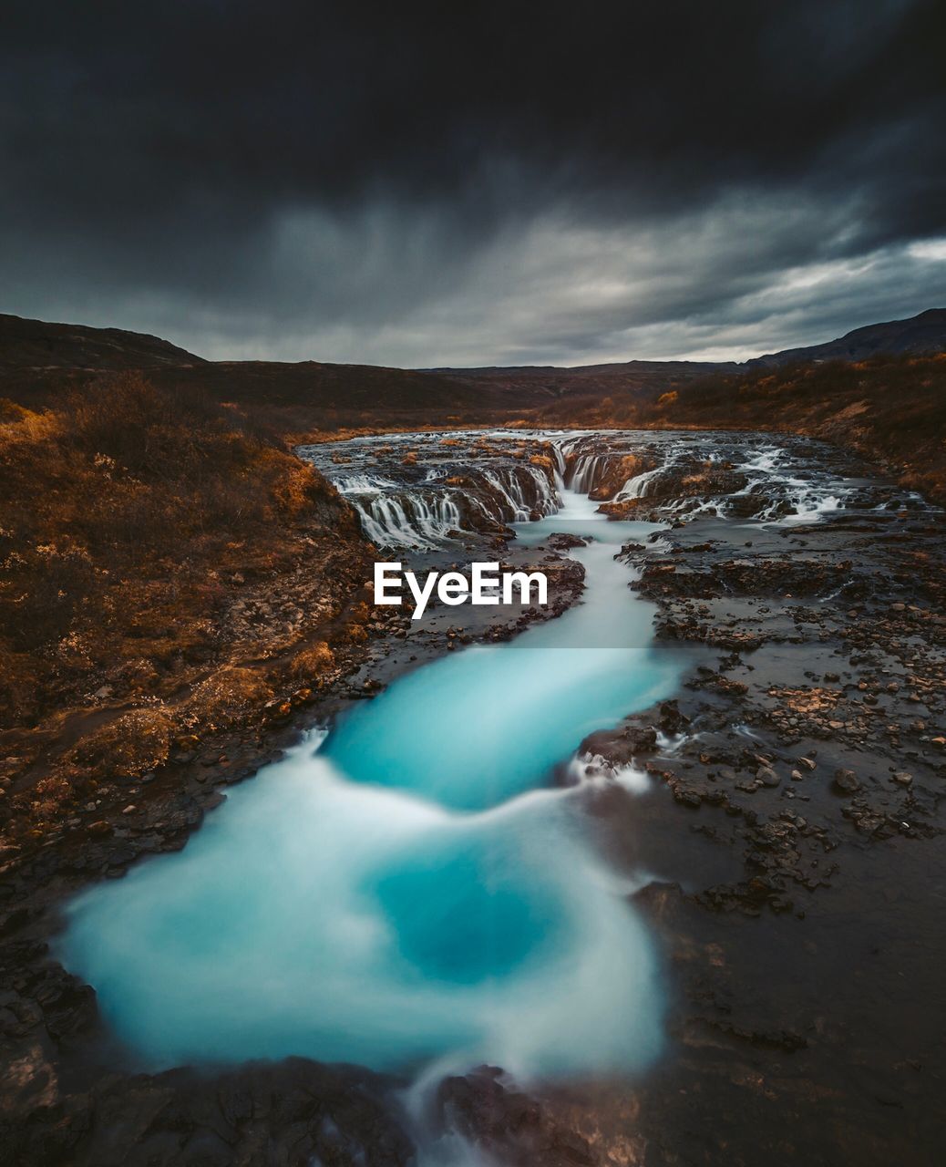 Scenic view of waterfall against sky