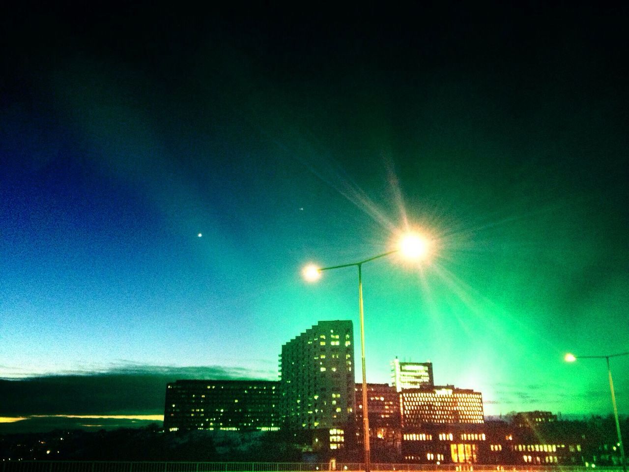 LOW ANGLE VIEW OF MODERN BUILDING AT NIGHT