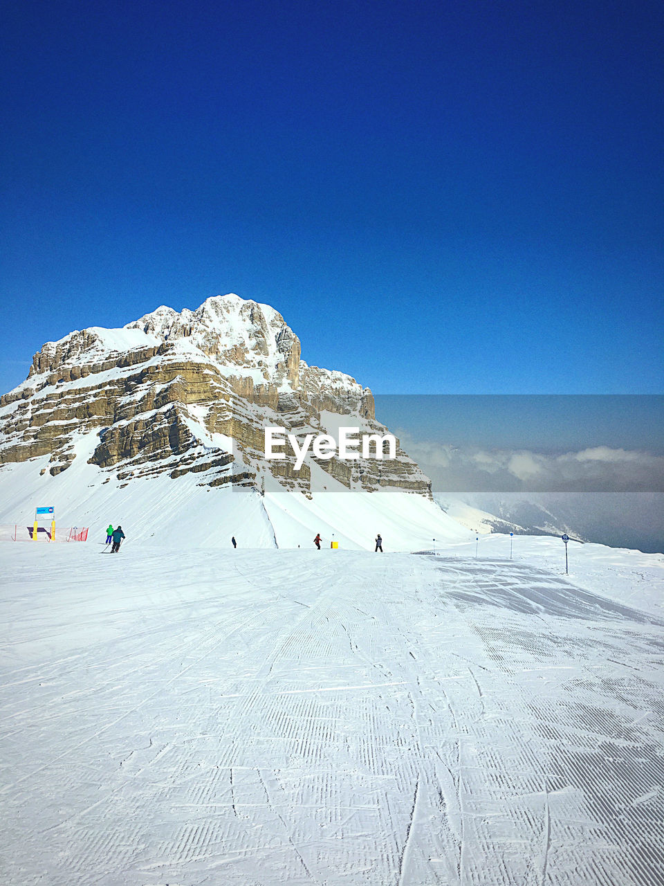 Scenic view of snowcapped mountain against blue sky