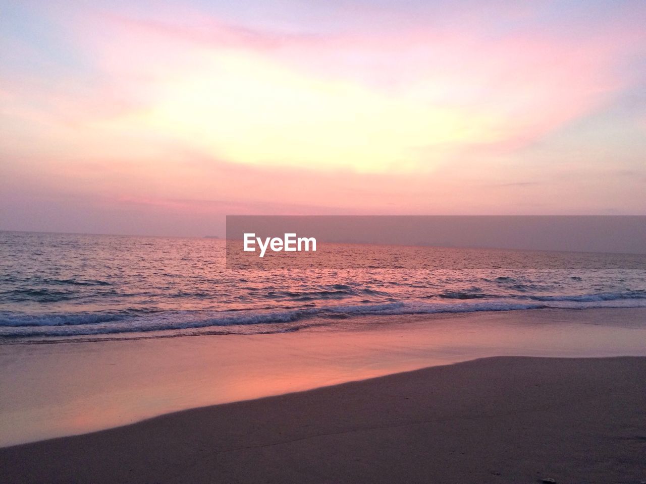 Scenic view of beach against sky during sunset