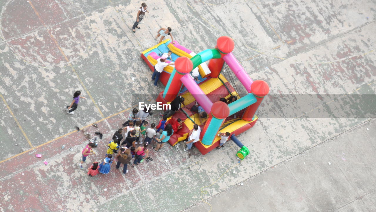 High angle view of people by bouncy castle on street