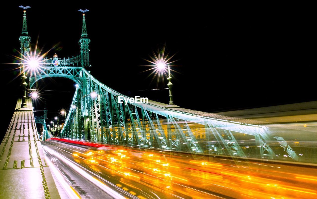 Illuminated bridge at night