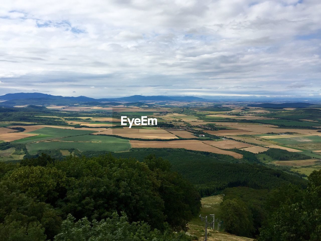 Scenic view of landscape against cloudy sky