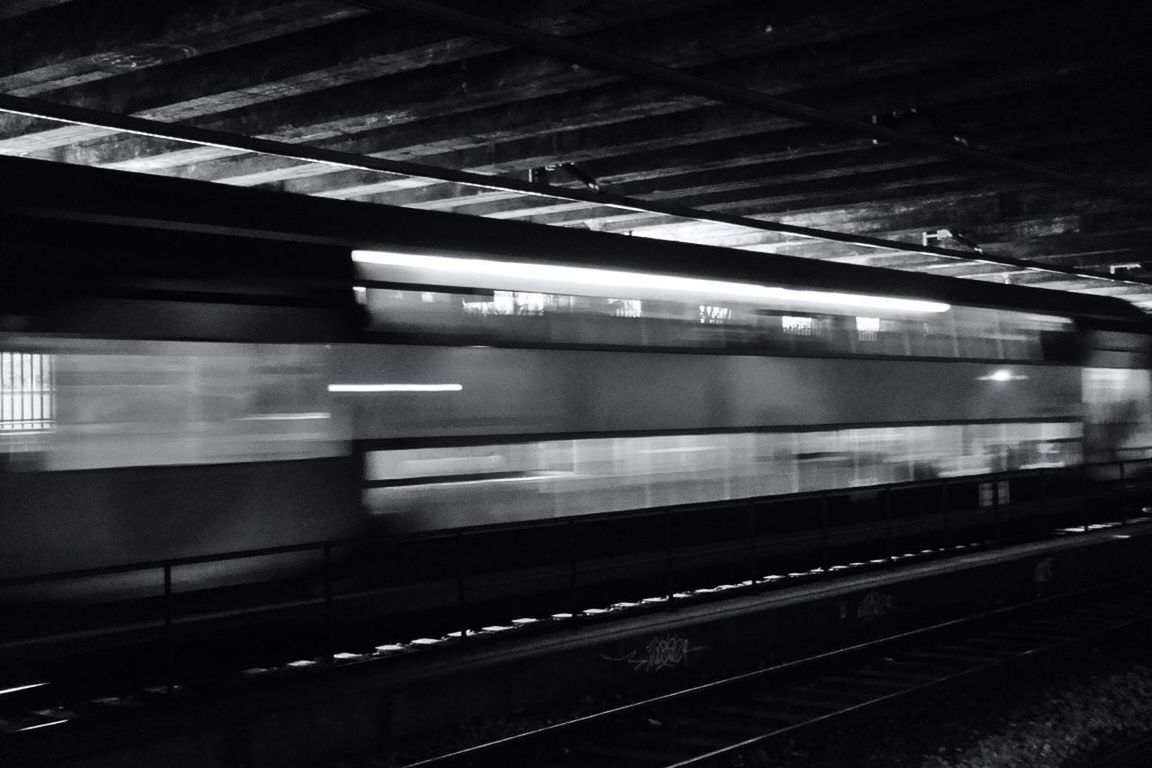 TRAIN ON RAILROAD STATION PLATFORM