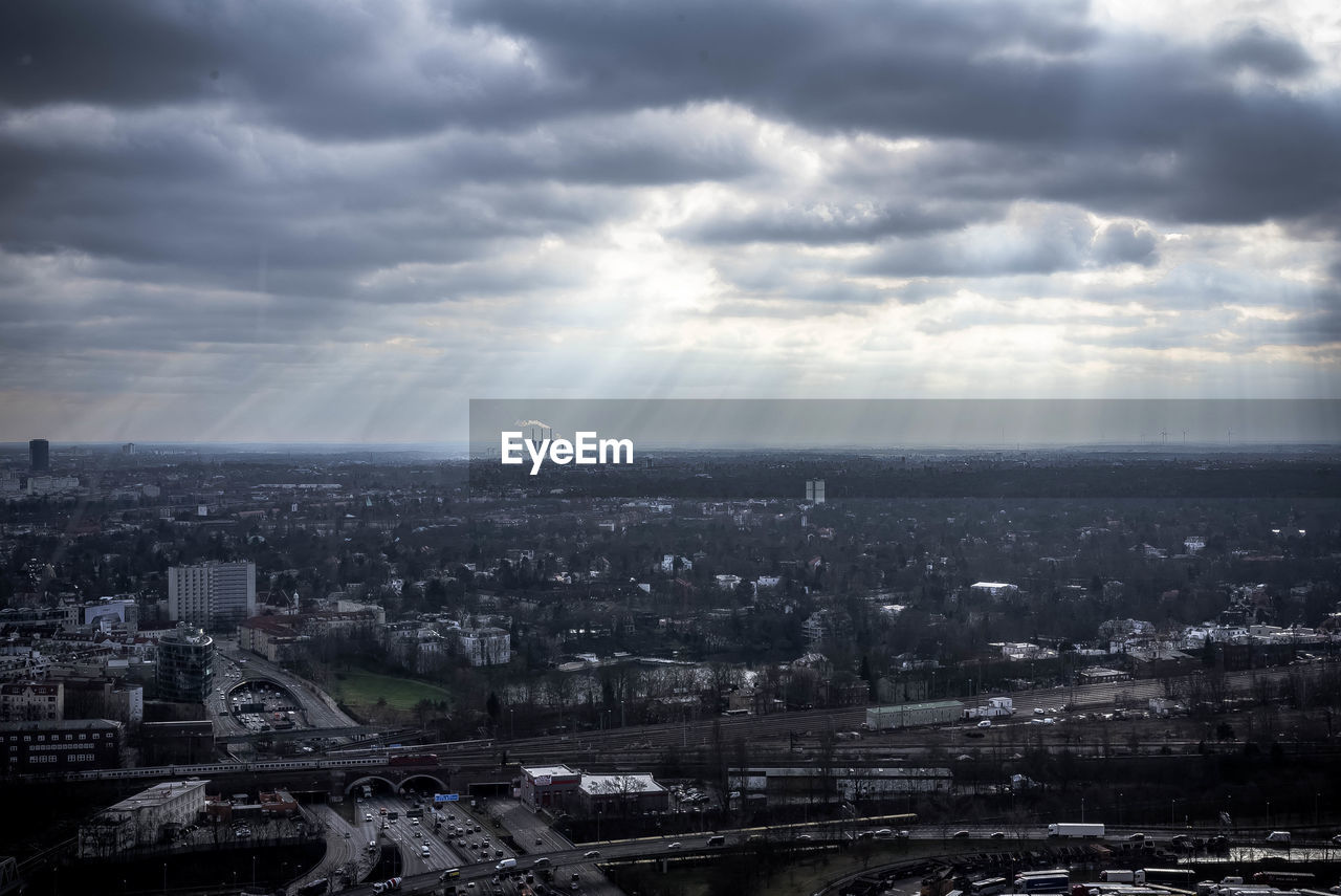 Aerial view of city against cloudy sky