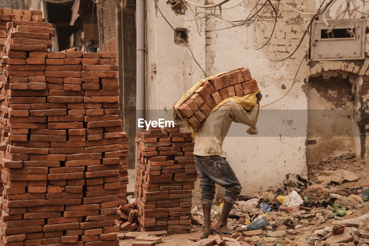 Man working on brick wall