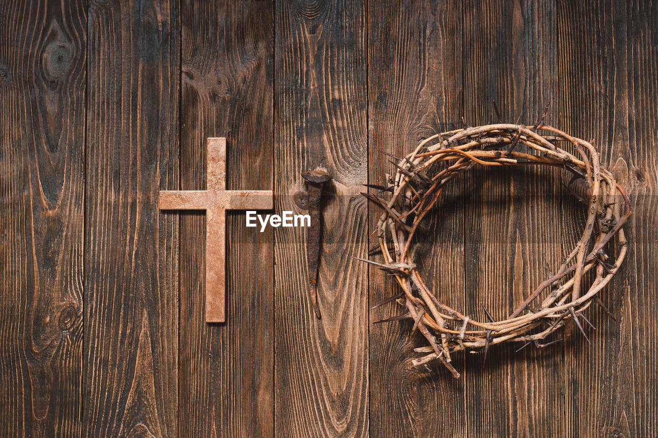 Jesus crown thorns and nails and cross on a wood background. easter day