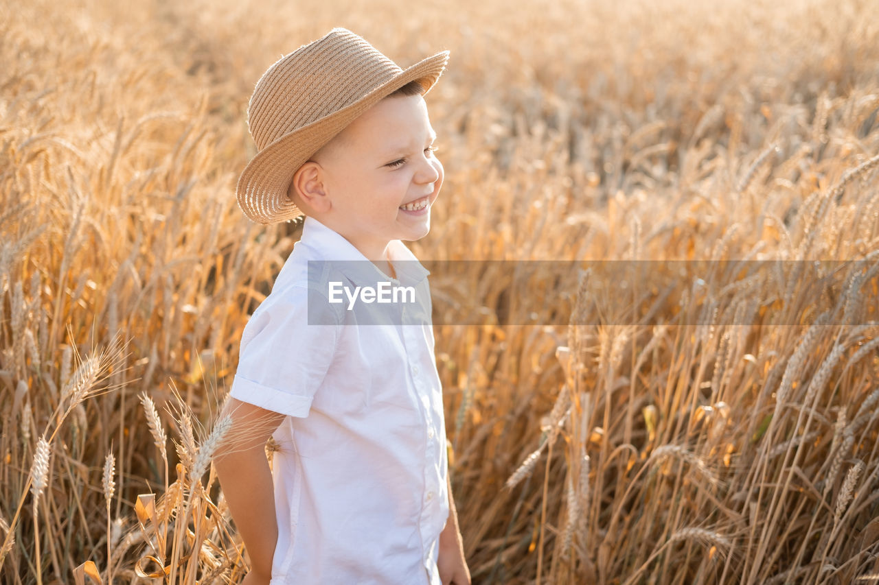 rear view of girl standing on hay