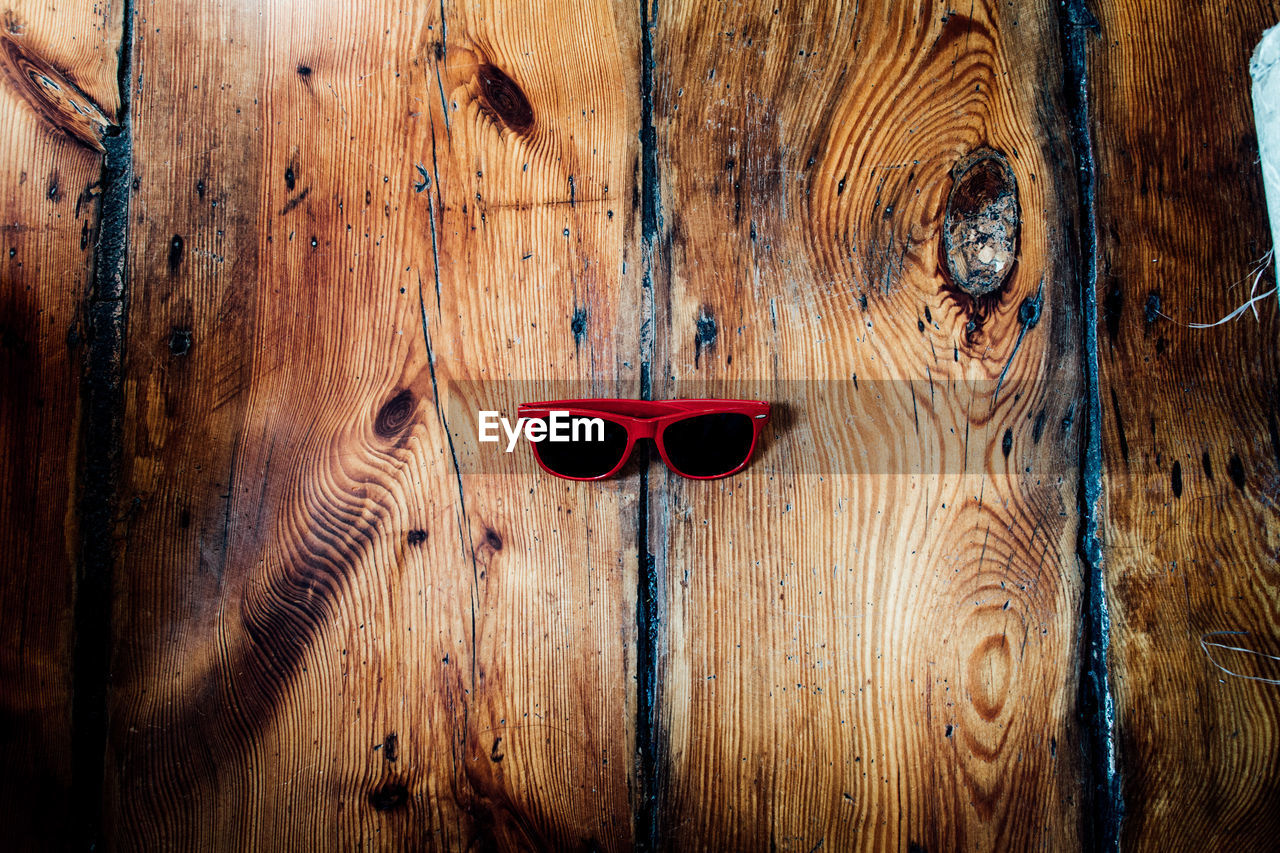 High angle view of sunglasses on wooden table