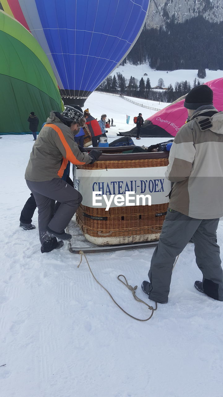 PEOPLE ON SNOW COVERED LAND