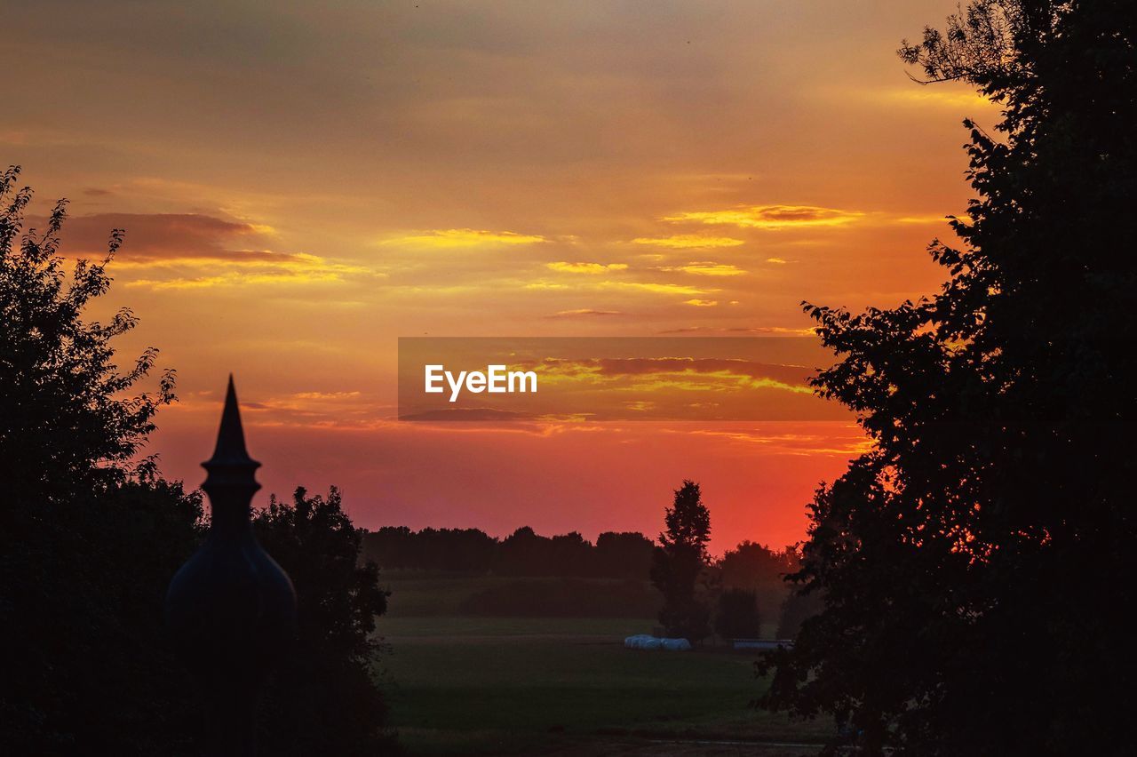 SILHOUETTE TREES AND TEMPLE AGAINST SKY DURING SUNSET