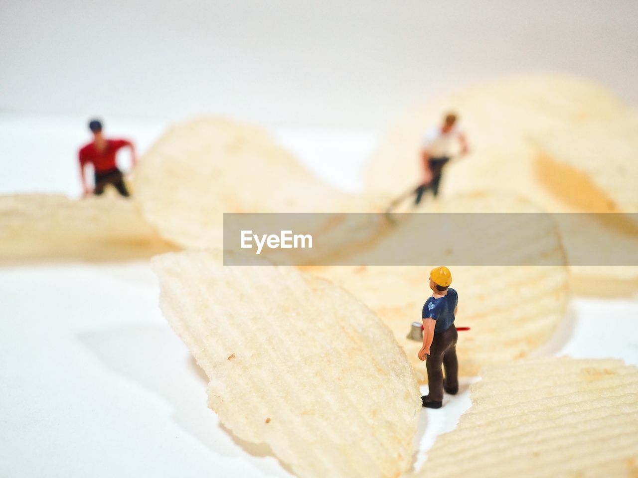 Close-up of figurines on potato chips