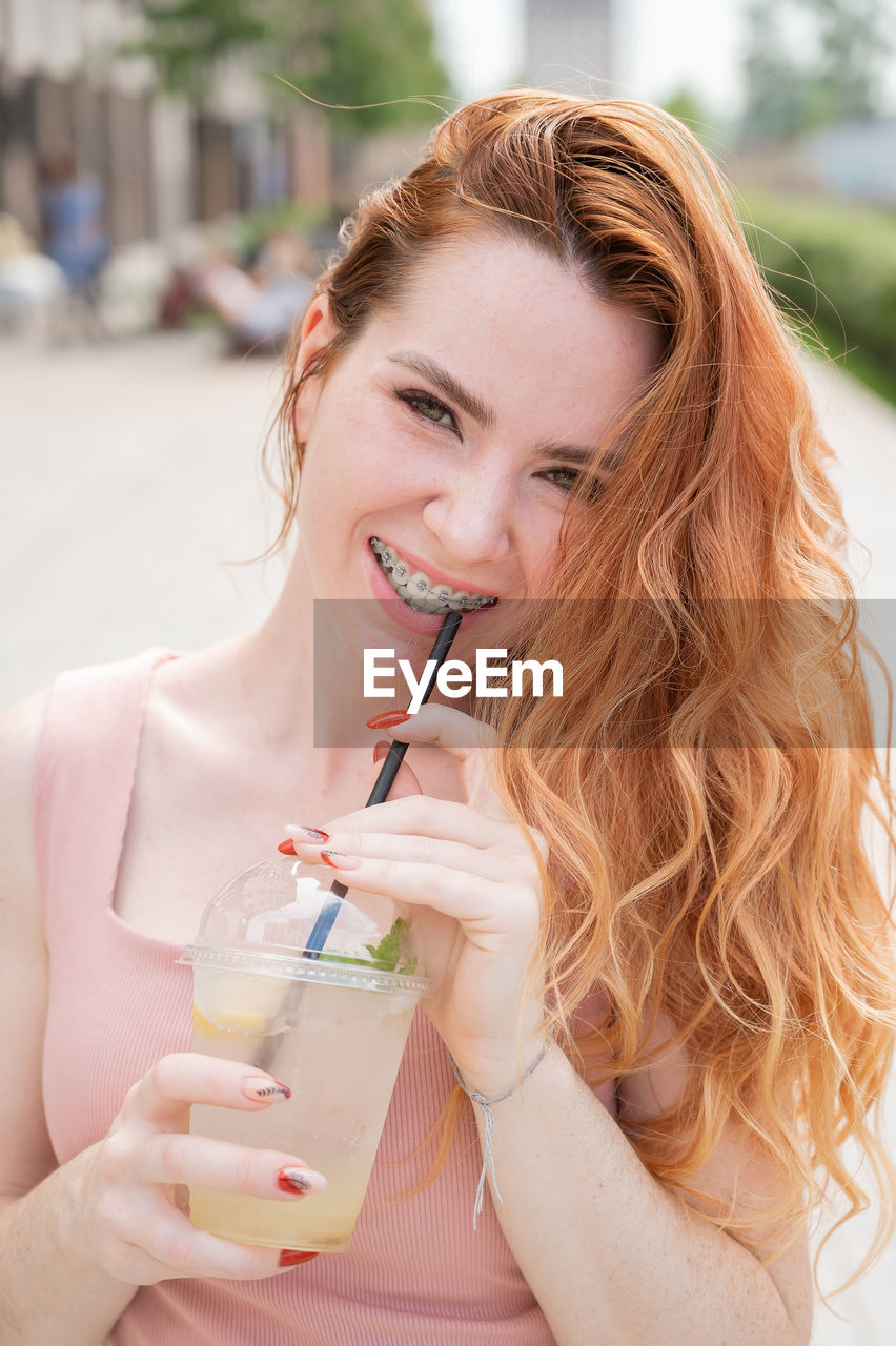 portrait of young woman drinking glass