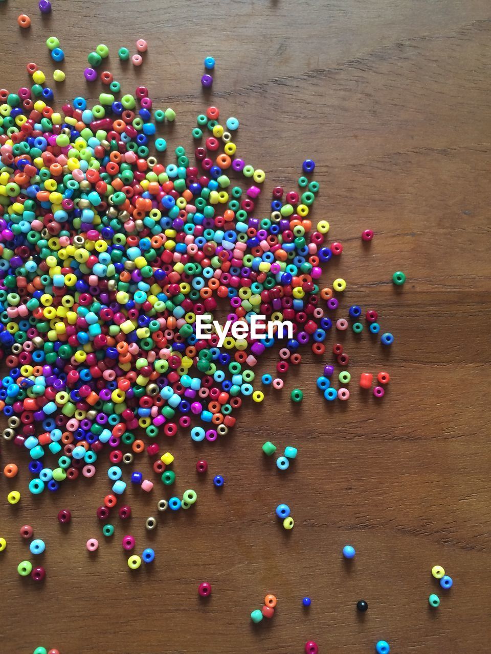 High angle view of multi colored beads on table