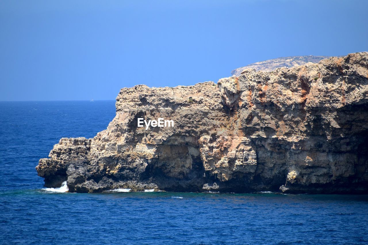 Scenic view of sea against clear blue sky